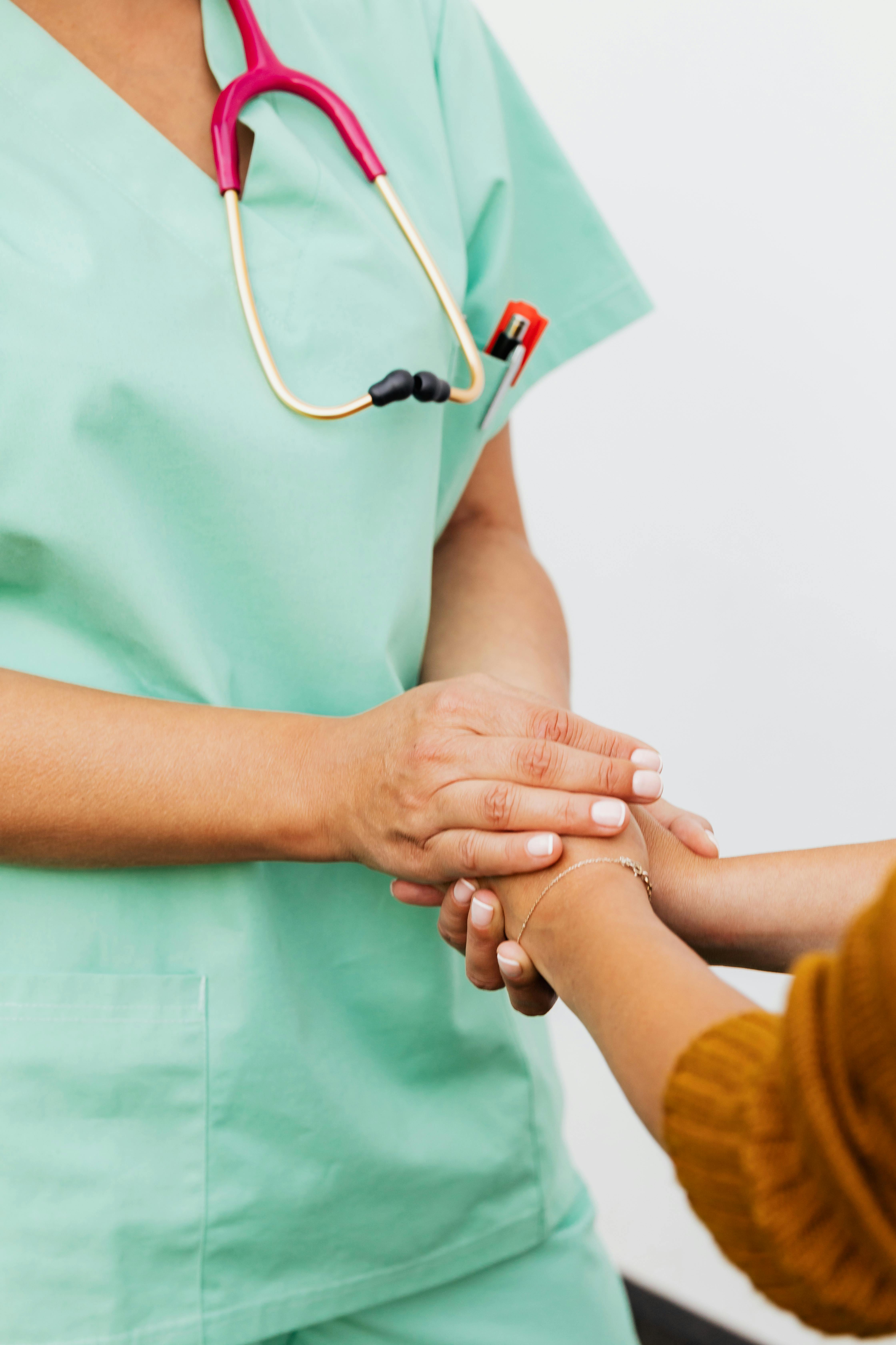 Nurse holding hands with a patient